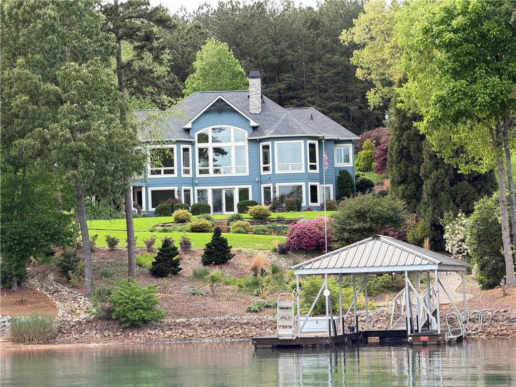 357 Stardust Lane Seneca, SC 29672 - Photo 3 of 50 A striking multi-level home overlooks calm waters with a private covered boat dock.