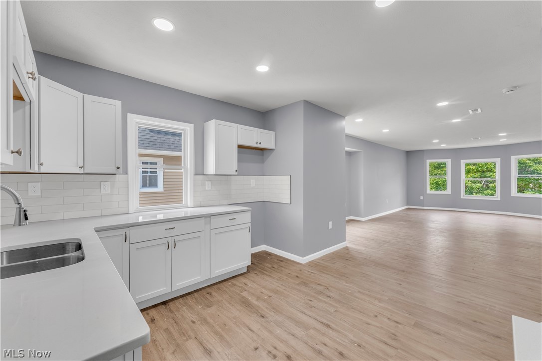 3925 Riverside Avenue Cleveland, OH 44109 - Photo 29 of 46 Open concept living area featuring wood-finish flooring, recessed lighting, and multiple windows