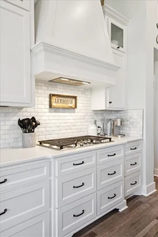 a bedroom with a bed and a dresser next to a window