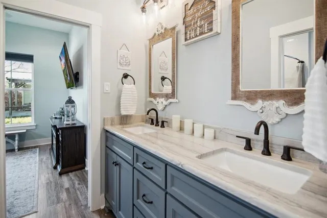 a view of a house with a big yard and large tree