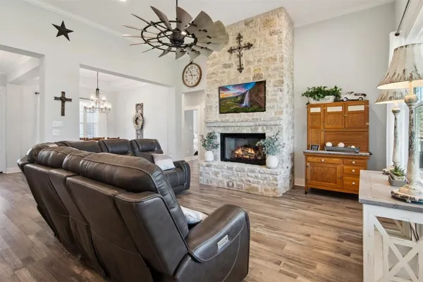 a living room with furniture a fireplace and a flat screen tv
