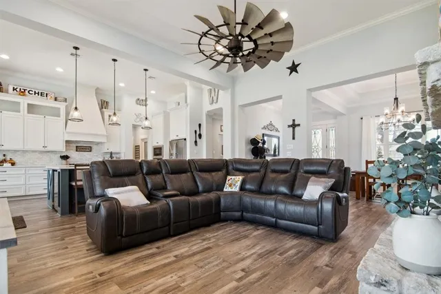 a living room with furniture a fireplace and a large window