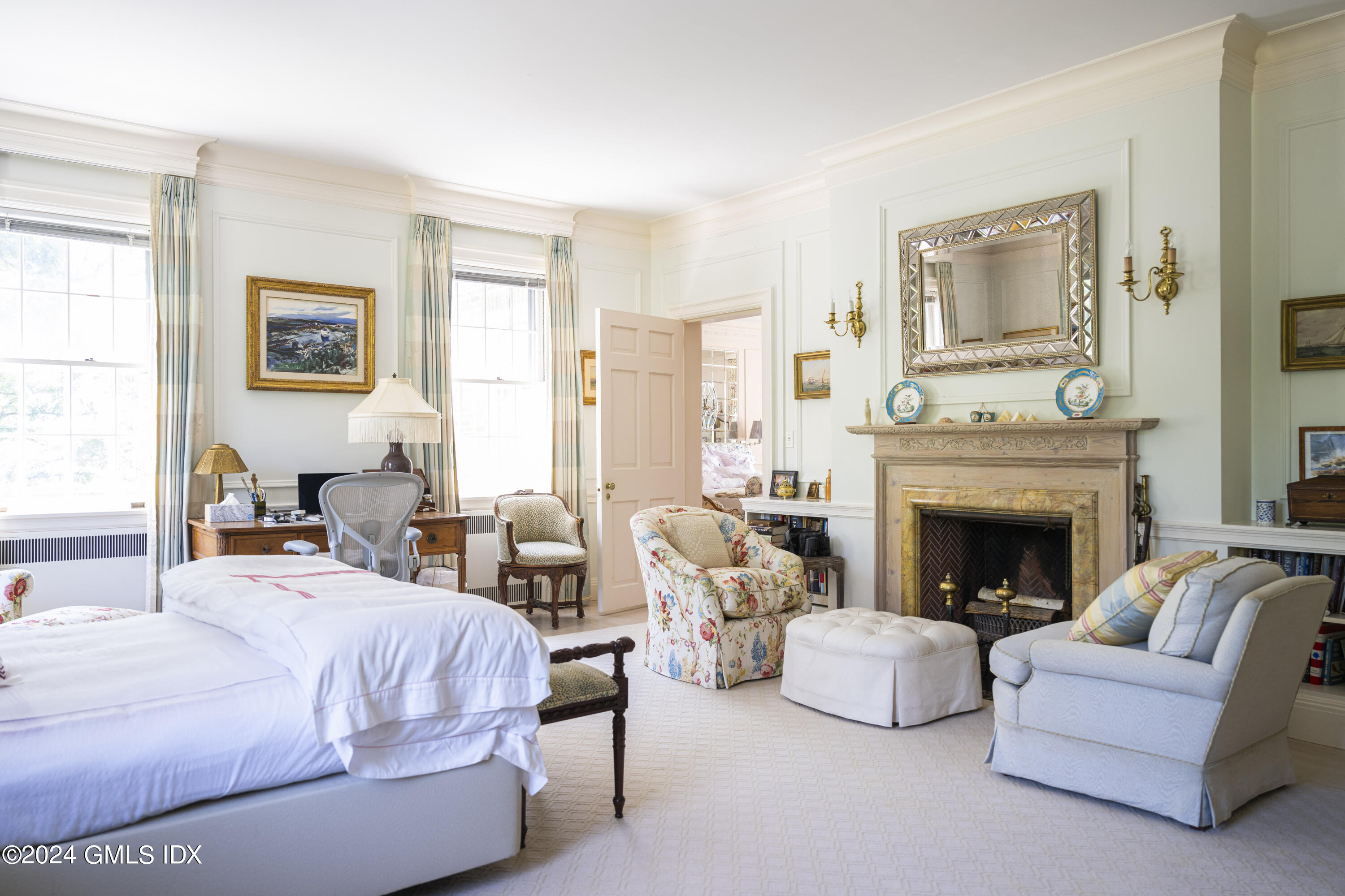 10 Cliffdale Road Greenwich, CT 06831 - Photo 20 of 31 a bedroom with a large bed and a fireplace