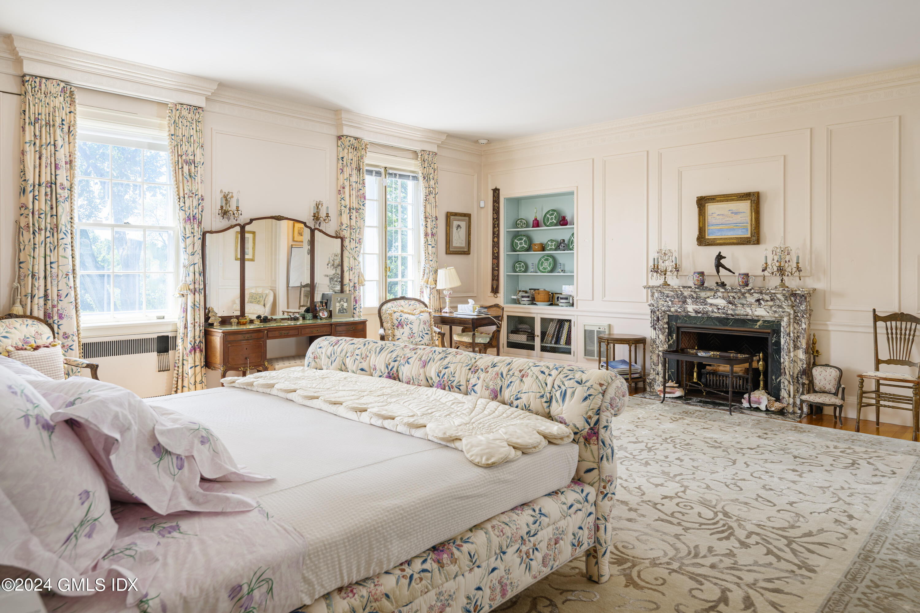10 Cliffdale Road Greenwich, CT 06831 - Photo 23 of 31 a bed sitting in a spacious bedroom next to a window and a fireplace