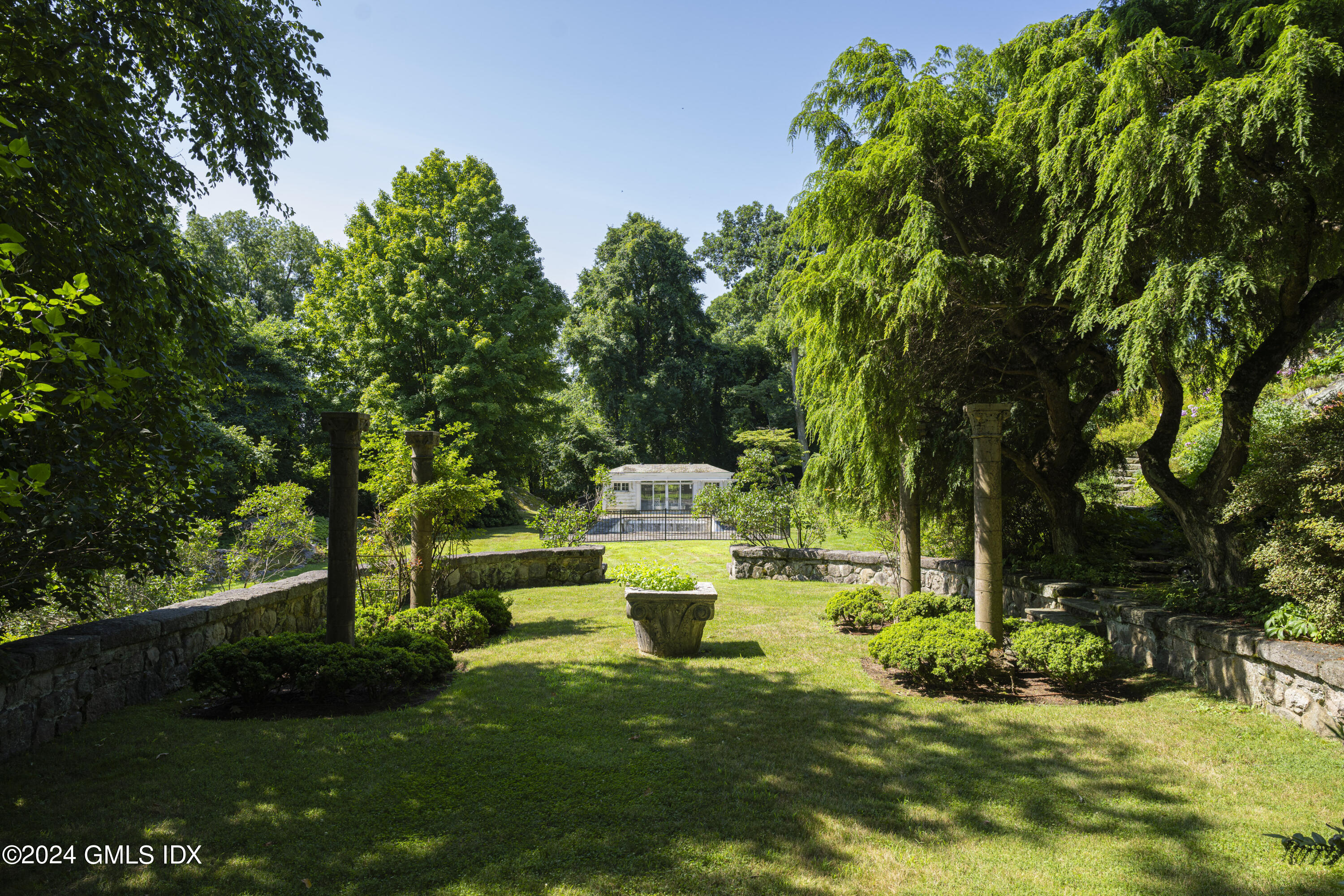 10 Cliffdale Road Greenwich, CT 06831 - Photo 25 of 31 a view of a house with backyard sitting area and garden
