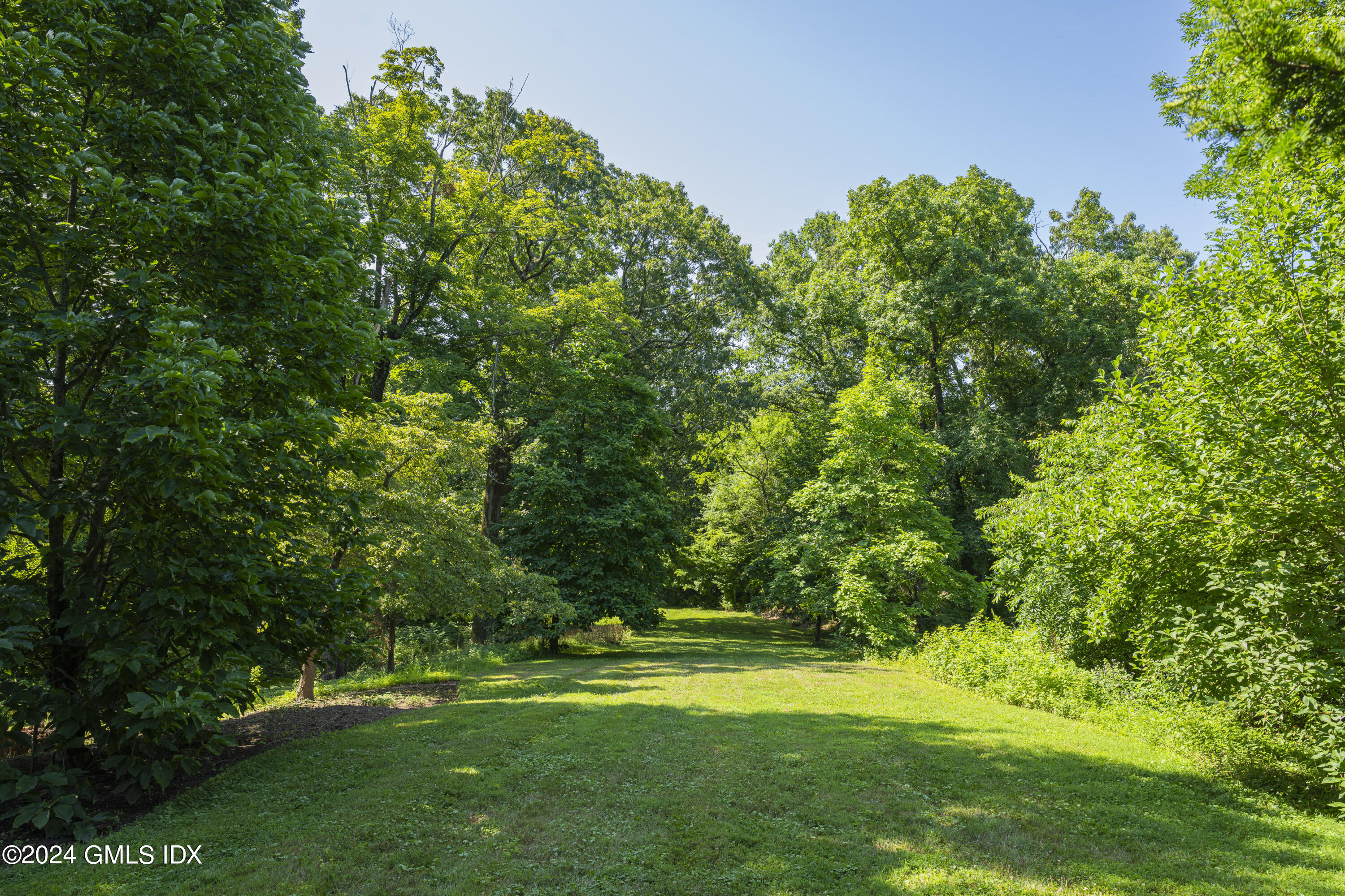 10 Cliffdale Road Greenwich, CT 06831 - Photo 27 of 31 a view of a grassy field with trees