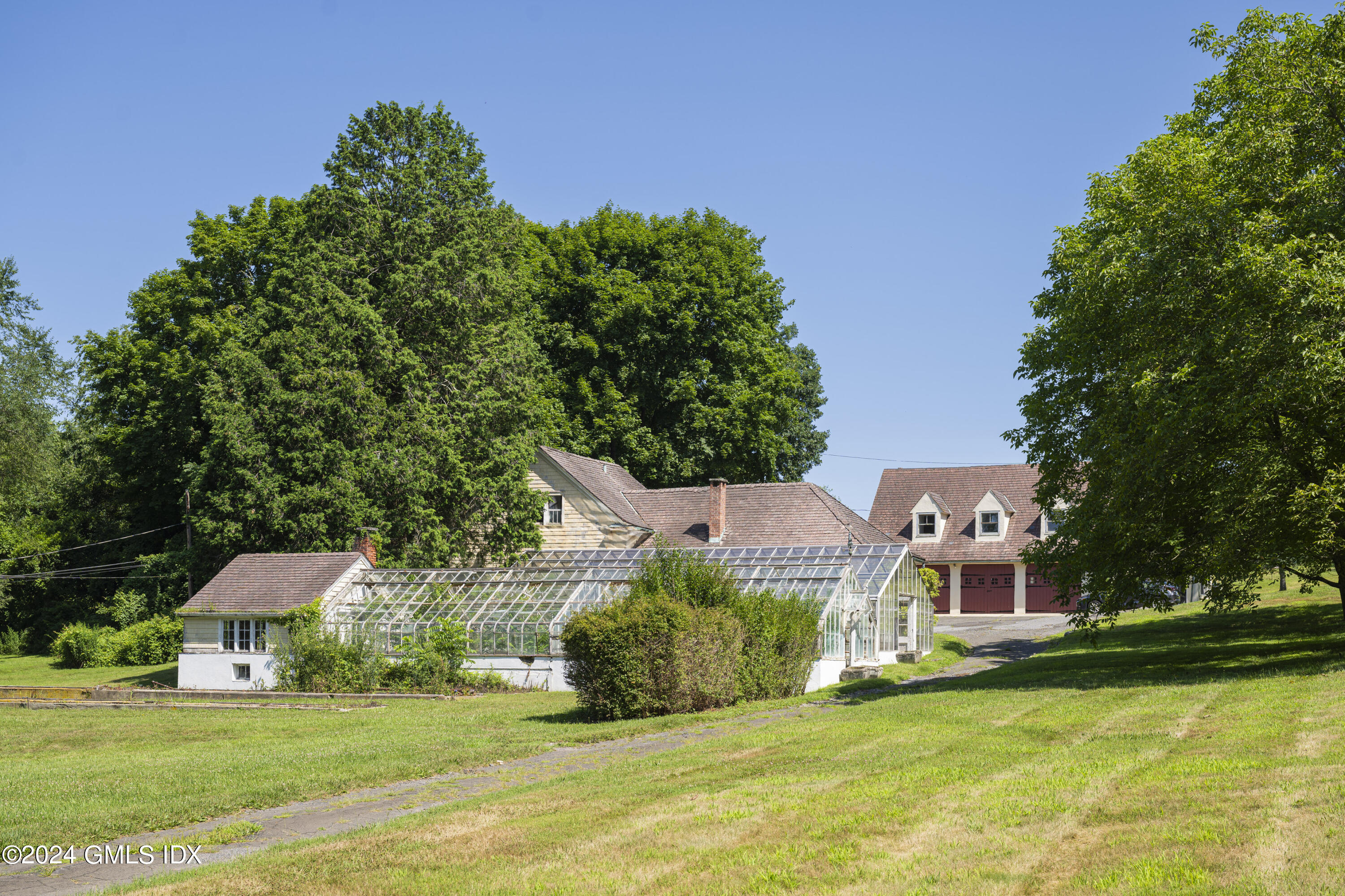 10 Cliffdale Road Greenwich, CT 06831 - Photo 29 of 31 a view of a house with a yard porch and sitting area