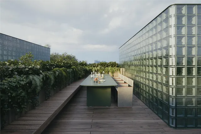a view of a balcony with wooden floor and plants