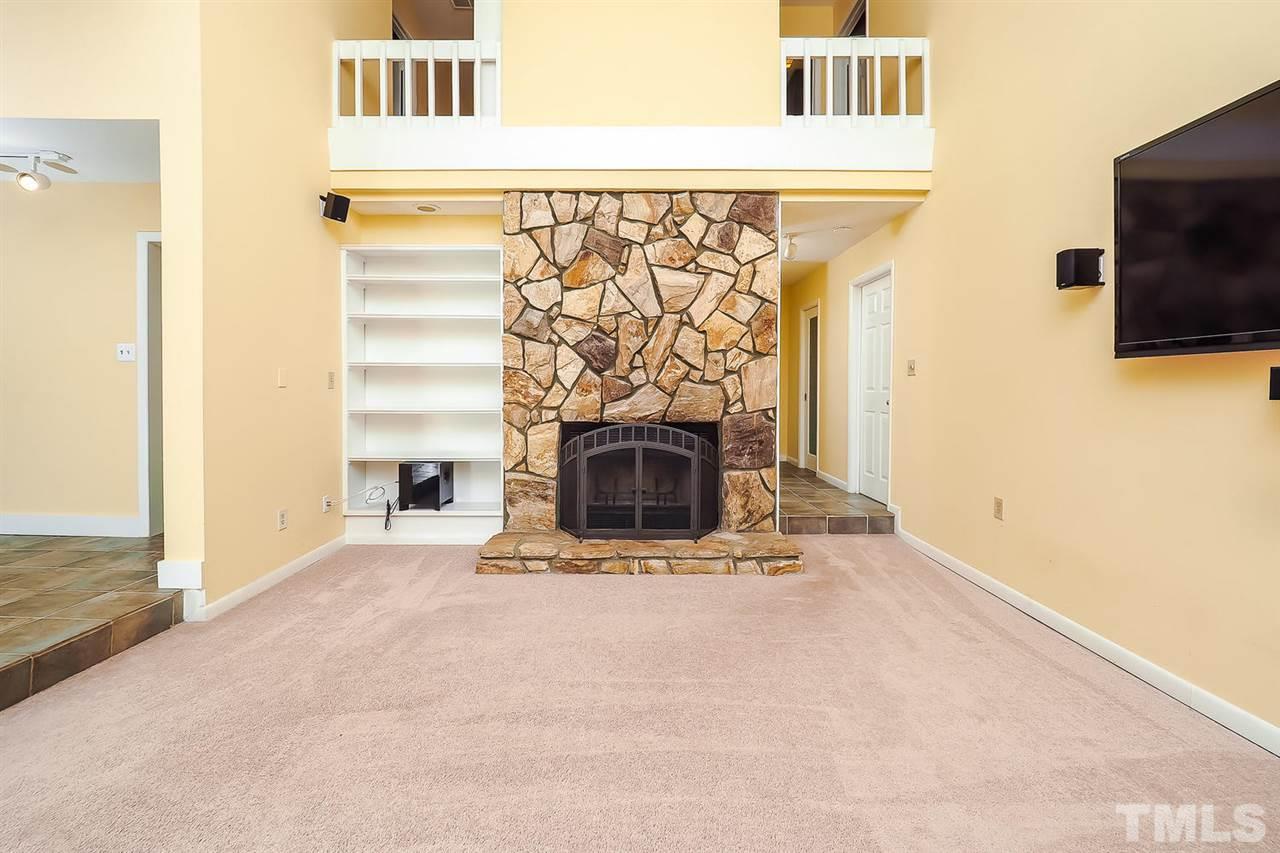 4009 Pleasant Grove Church Road Raleigh, NC 27613 - Photo 5 of 15 a view of a livingroom with a fireplace and a flat screen tv