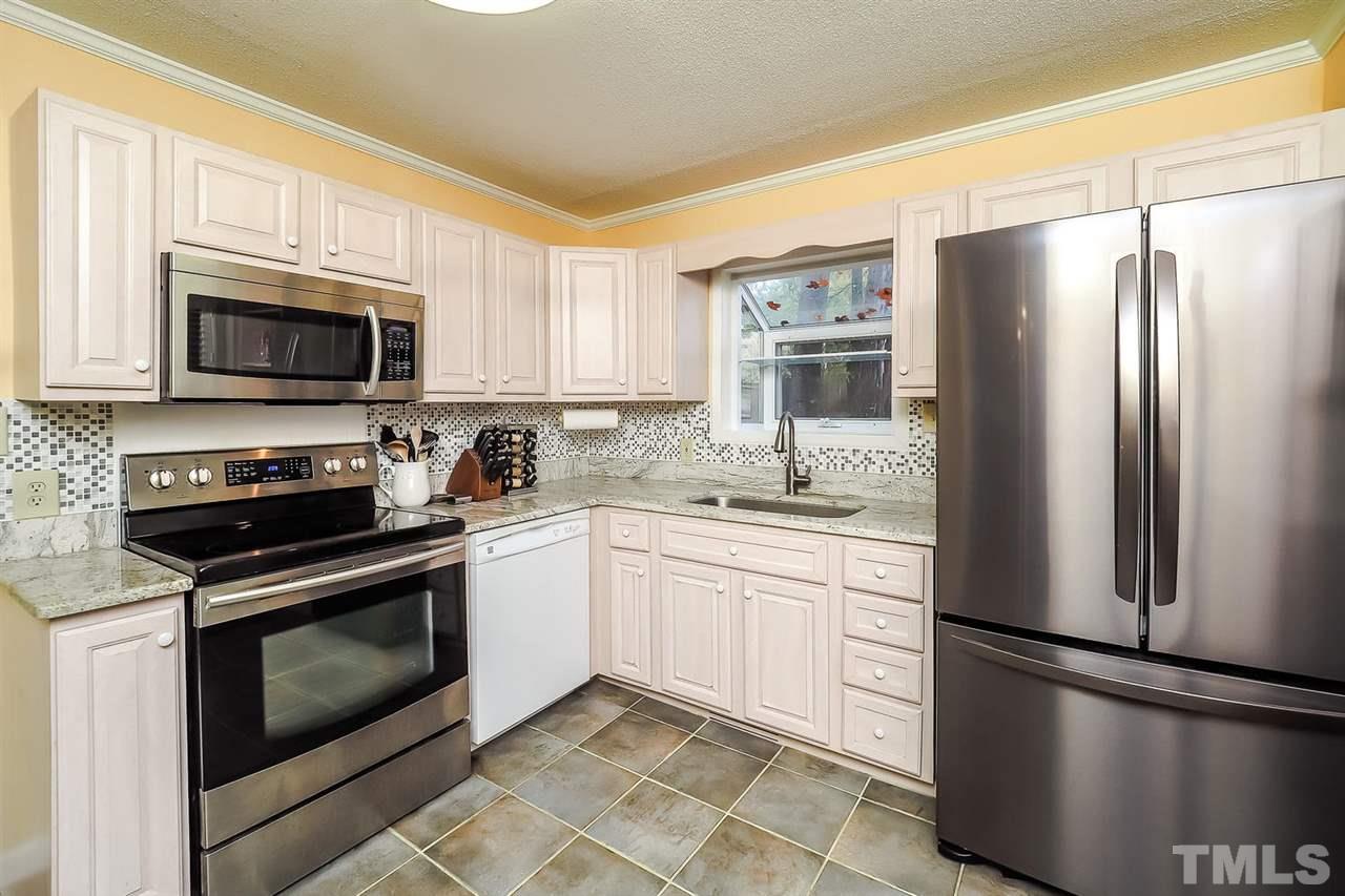 4009 Pleasant Grove Church Road Raleigh, NC 27613 - Photo 7 of 15 a kitchen with a refrigerator stove and microwave