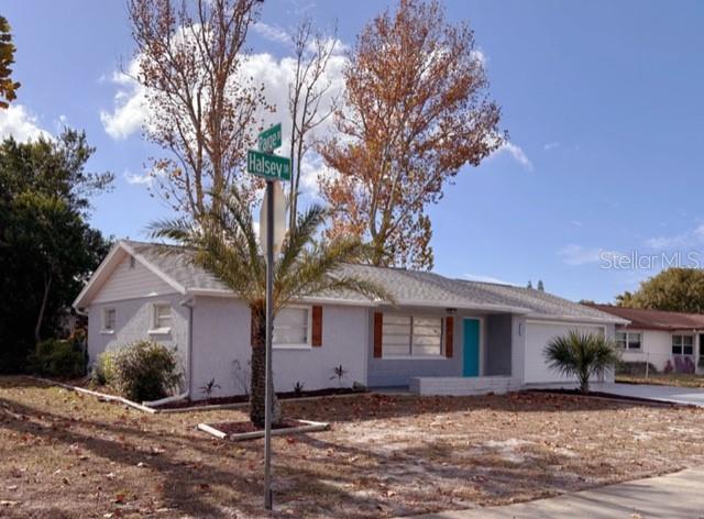 7924 Halsey Drive Port Richey, FL 34668 - Photo 22 of 26 a front view of a house with a yard