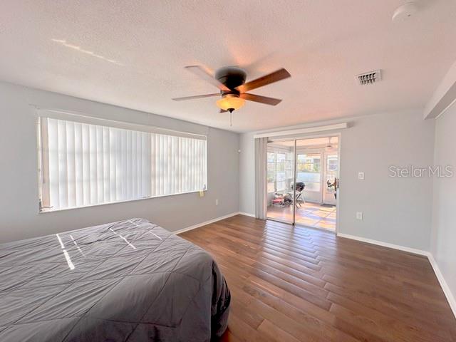 7924 Halsey Drive Port Richey, FL 34668 - Photo 4 of 26 a bedroom with bed and wooden floor
