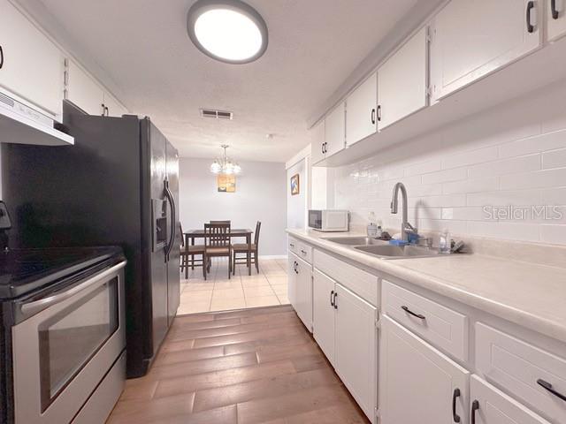 7924 Halsey Drive Port Richey, FL 34668 - Photo 5 of 26 a kitchen with counter top space cabinets and stainless steel appliances