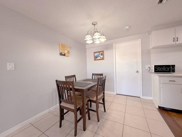 7924 Halsey Drive Port Richey, FL 34668 - Photo 6 of 26 a view of a dining room with furniture and chandelier