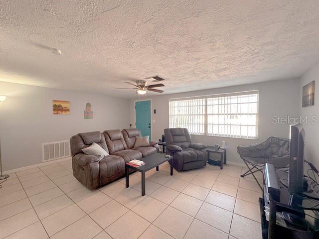 7924 Halsey Drive Port Richey, FL 34668 - Photo 7 of 26 a living room with furniture and a chandelier