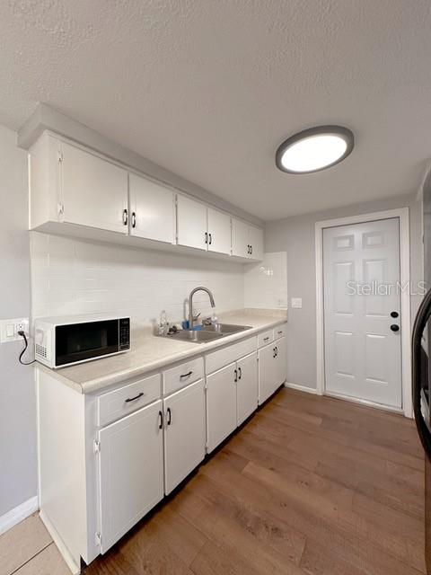 7924 Halsey Drive Port Richey, FL 34668 - Photo 8 of 26 a kitchen with granite countertop a sink and cabinets