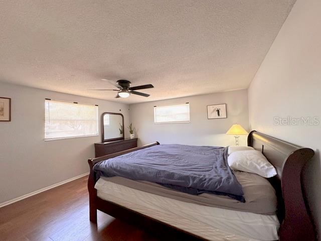 7924 Halsey Drive Port Richey, FL 34668 - Photo 10 of 26 a bedroom with a bed wooden floor and window