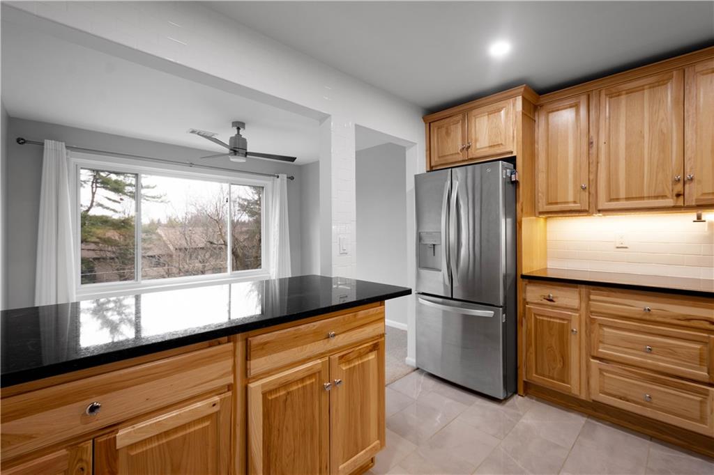 410 Abbeyville Road, Unit D Pittsburgh, PA 15228 - Photo 7 of 19 a kitchen with stainless steel appliances granite countertop a refrigerator and a sink