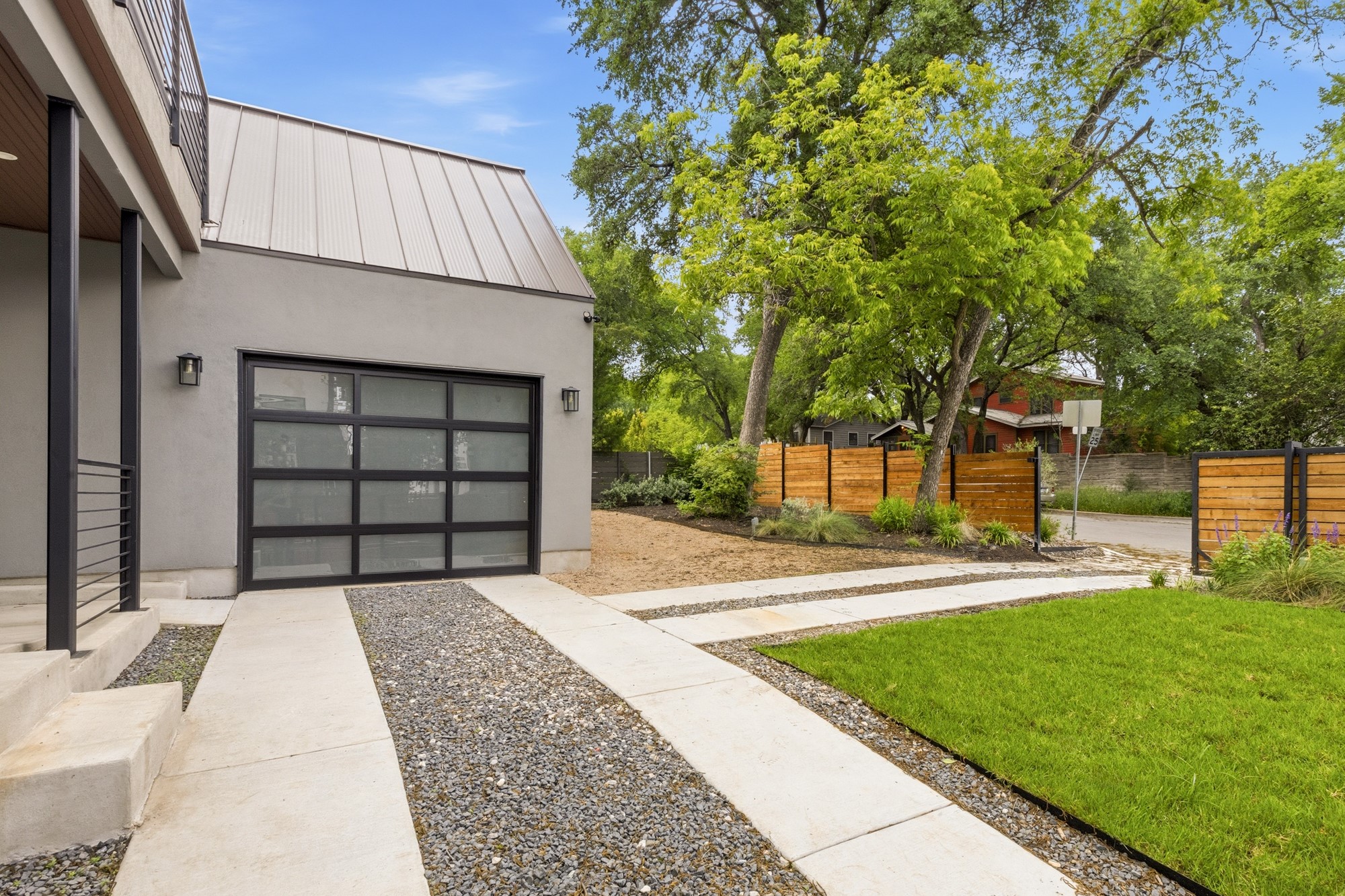 2300 Bluebonnet Lane Austin, TX 78704 - Photo 4 of 40 a front view of a house with a yard and garage
