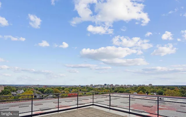 a walk in closet with clothes and shoes