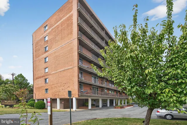 a backyard of a house with a garden and outdoor seating