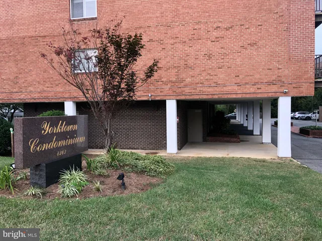 a front view of a building with trees