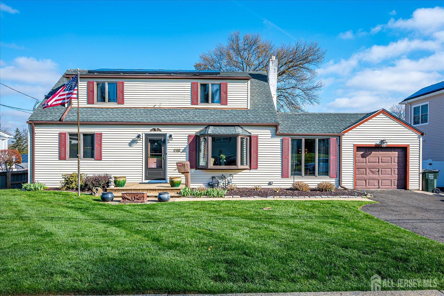 a front view of a house with sitting area and garden