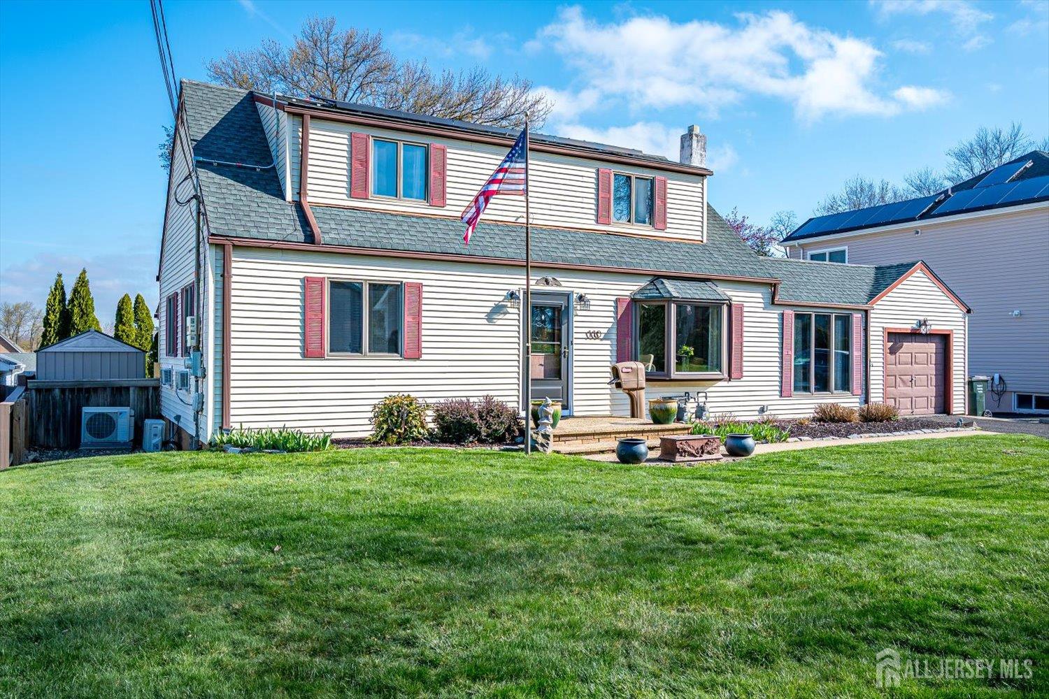 110 Normandy Road Colonia, NJ 07067 - Photo 2 of 57 a front view of a house with a yard and garage