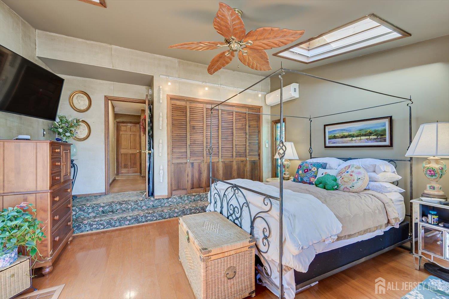 110 Normandy Road Colonia, NJ 07067 - Photo 21 of 57 a bedroom with a bed and a chandelier