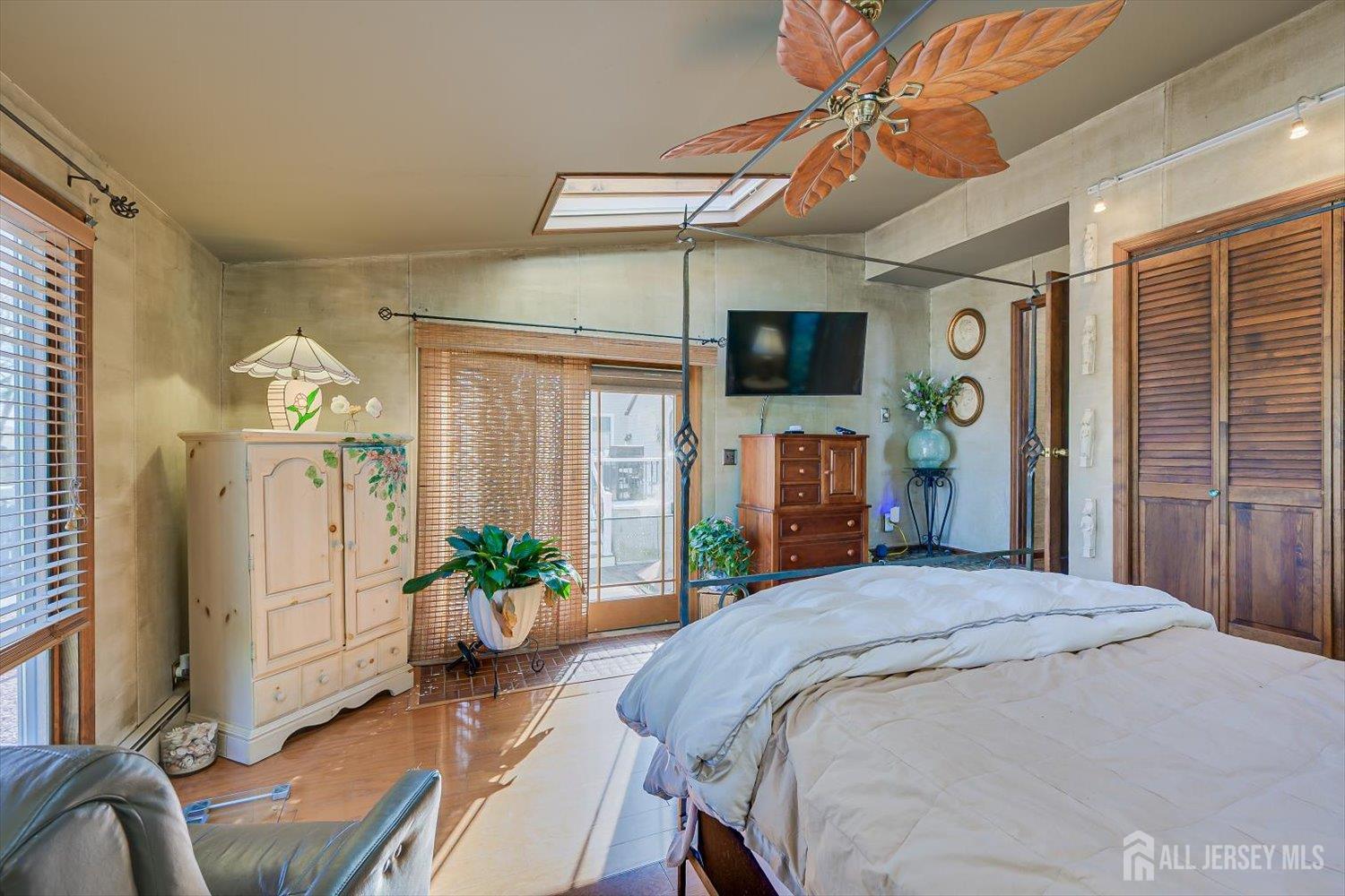 110 Normandy Road Colonia, NJ 07067 - Photo 22 of 57 a bedroom with a bed a flat screen tv and a chandelier
