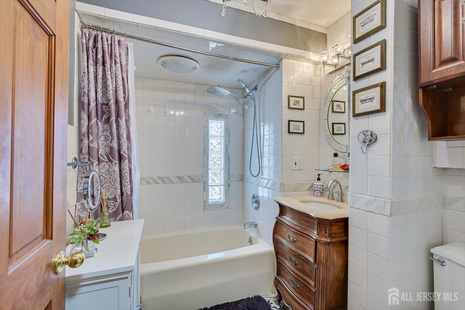 110 Normandy Road Colonia, NJ 07067 - Photo 23 of 57 a bathroom with a bathtub a sink and a shower