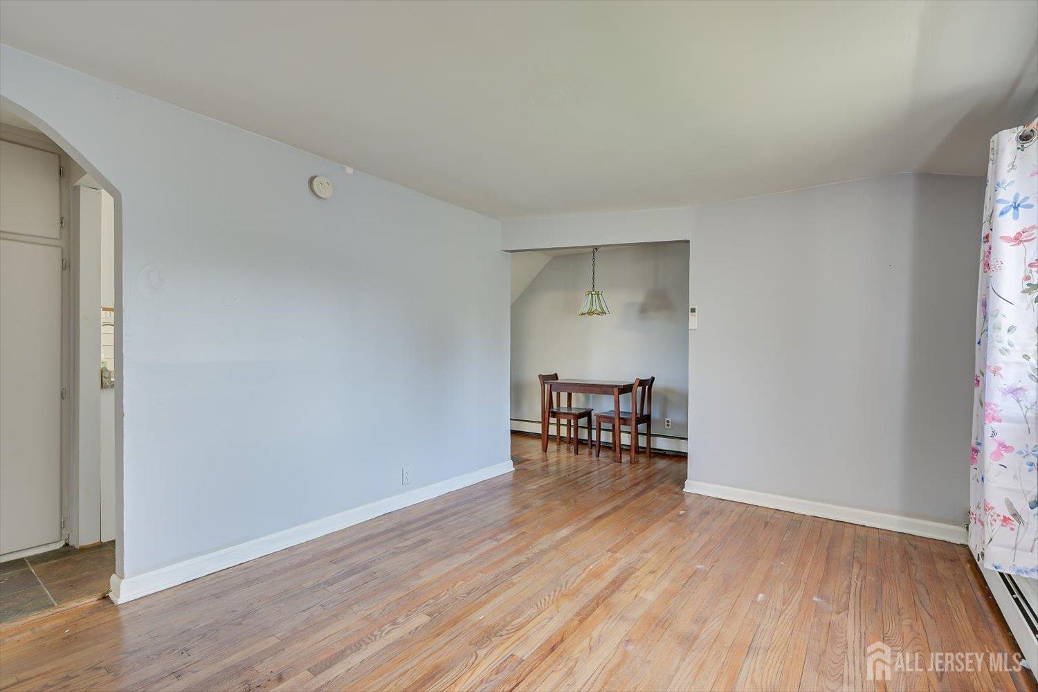 110 Normandy Road Colonia, NJ 07067 - Photo 30 of 57 an empty room with wooden floor and a window