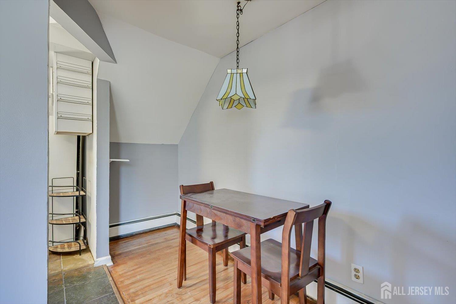 110 Normandy Road Colonia, NJ 07067 - Photo 32 of 57 a dining room with a table and chairs
