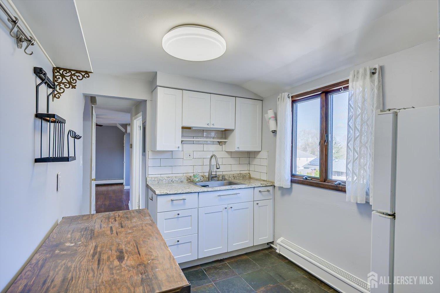 110 Normandy Road Colonia, NJ 07067 - Photo 33 of 57 a kitchen with a refrigerator and microwave