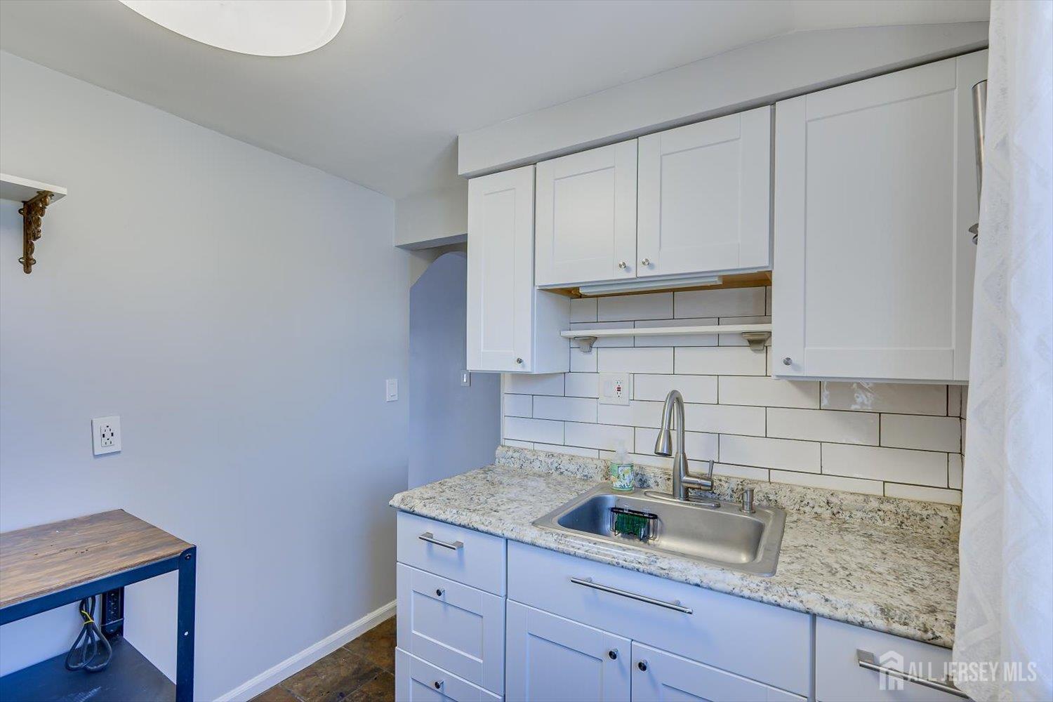110 Normandy Road Colonia, NJ 07067 - Photo 35 of 57 a kitchen with a sink and cabinets