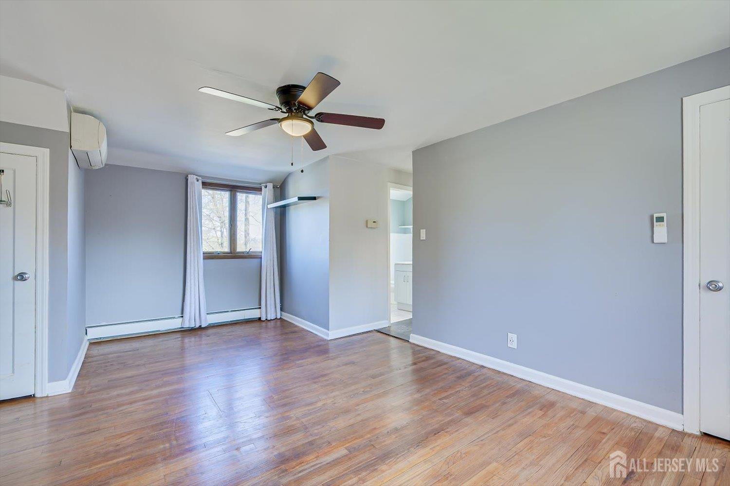 110 Normandy Road Colonia, NJ 07067 - Photo 38 of 57 a view of empty room with wooden floor and ceiling fan