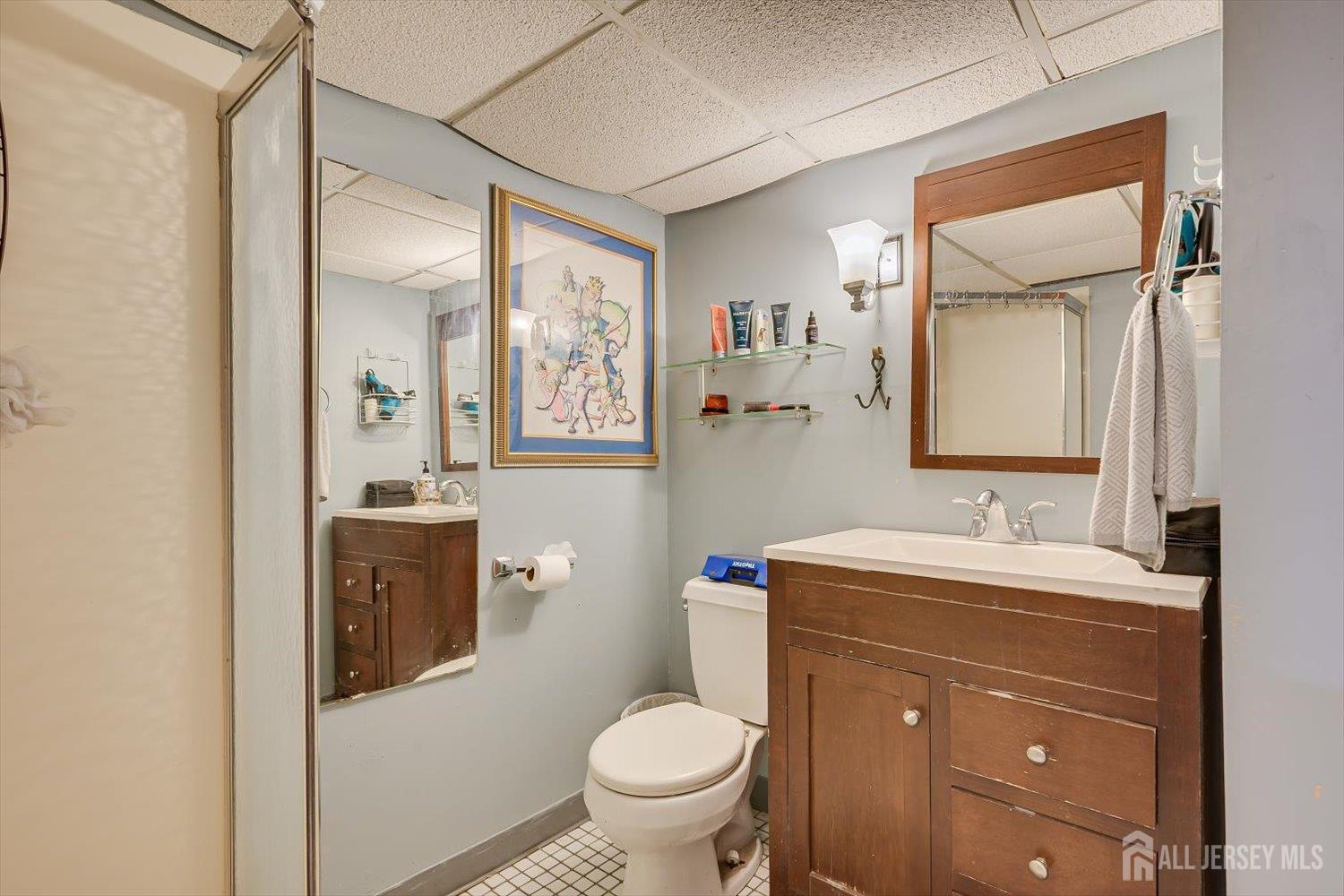 110 Normandy Road Colonia, NJ 07067 - Photo 42 of 57 a bathroom with a toilet sink vanity and mirror