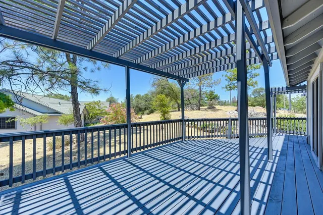a view of a hallway with wooden floor and entryway