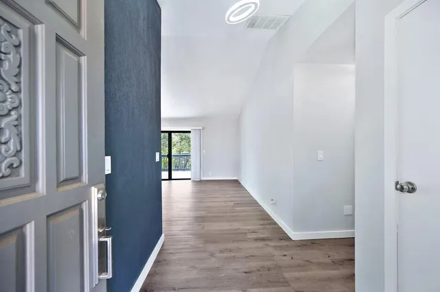 a kitchen with stainless steel appliances granite countertop hardwood a kitchen island sink stove and refrigerator