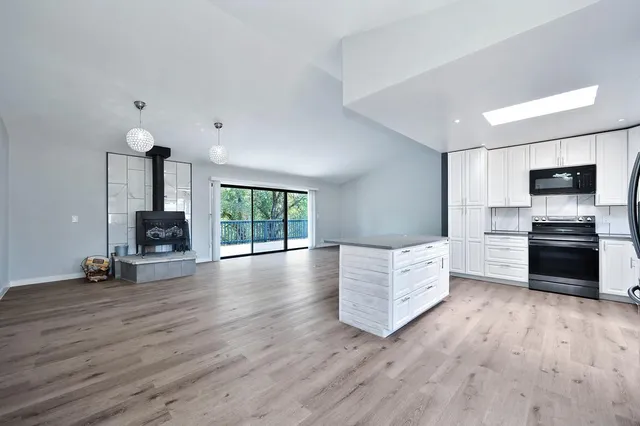 an empty room with a ceiling fan and a window