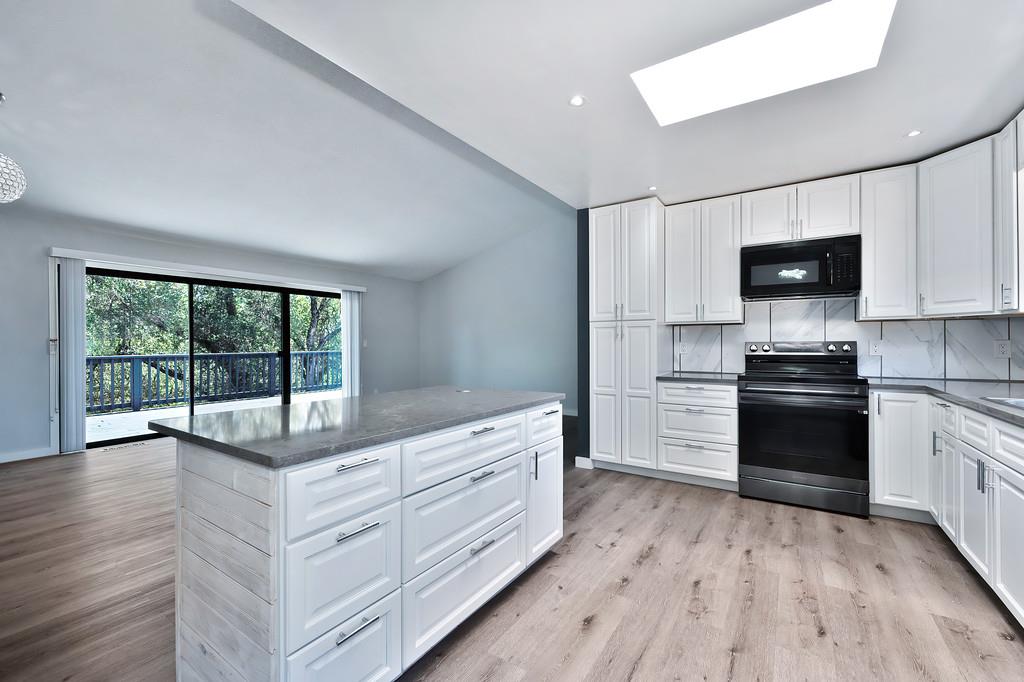 2071 Bogus Point Court Cool, CA 95614 - Photo 29 of 69 a kitchen with granite countertop a refrigerator and a stove top oven