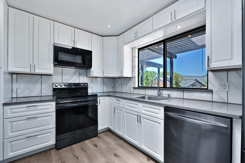 2071 Bogus Point Court Cool, CA 95614 - Photo 31 of 69 a kitchen with a sink stove and microwave