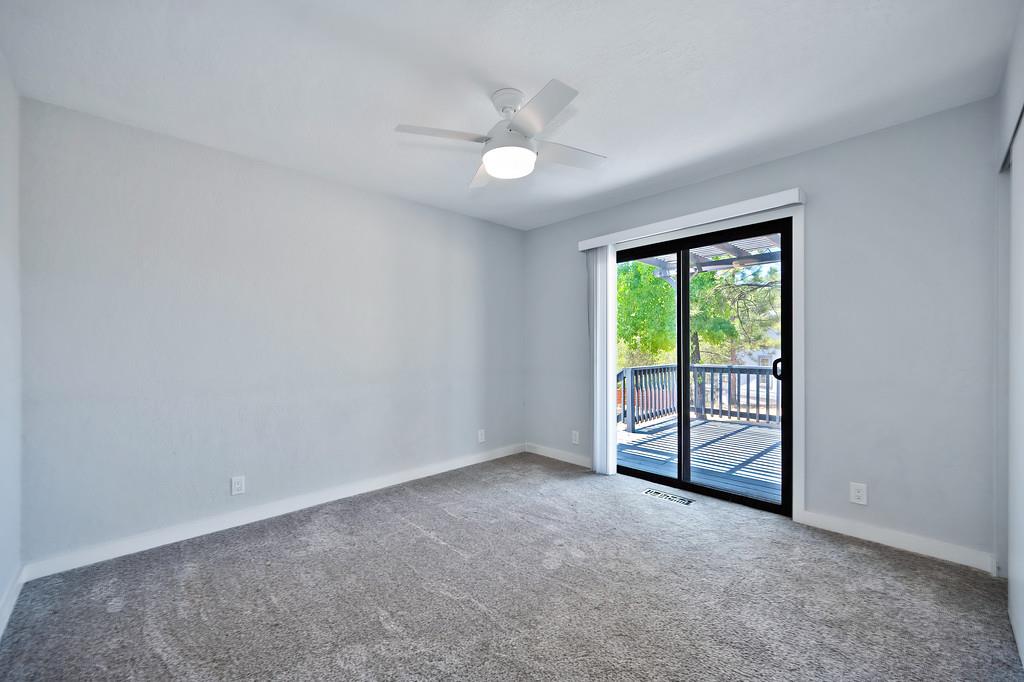2071 Bogus Point Court Cool, CA 95614 - Photo 34 of 69 an empty room with windows and ceiling fan