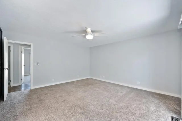 a view of backyard with a balcony and wooden floor