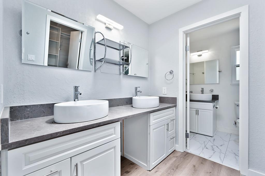 2071 Bogus Point Court Cool, CA 95614 - Photo 41 of 69 a bathroom with a granite countertop sink mirror and cabinets