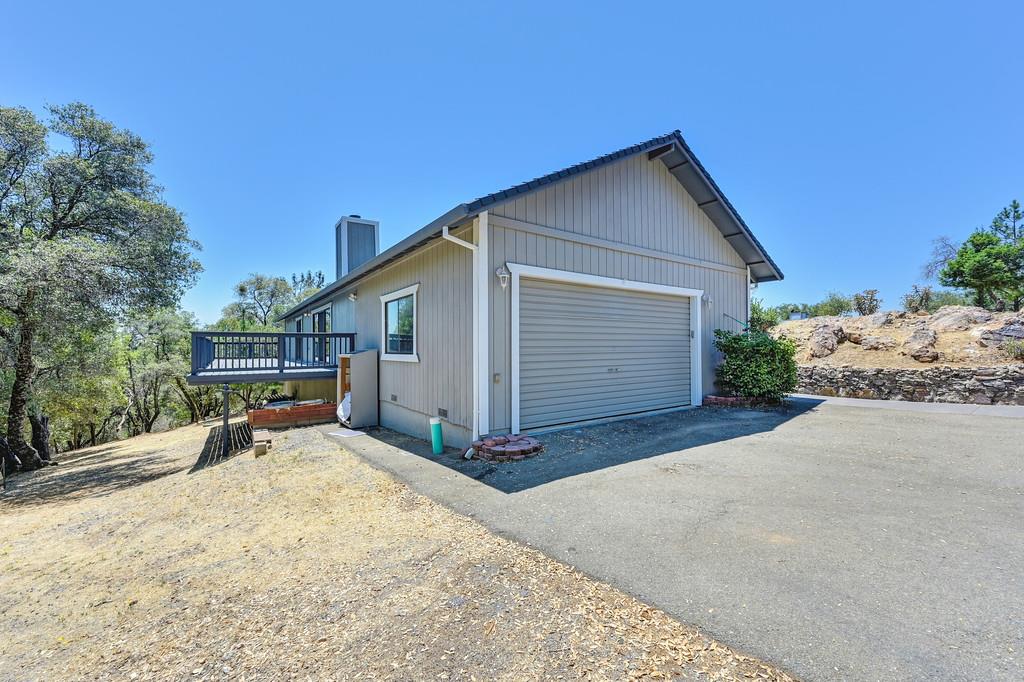 2071 Bogus Point Court Cool, CA 95614 - Photo 52 of 69 a view of a house with backyard and trees in the background