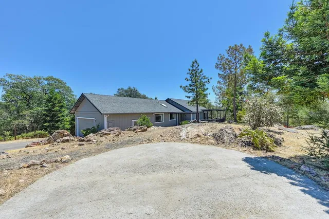 a view of a house with a snow in the background