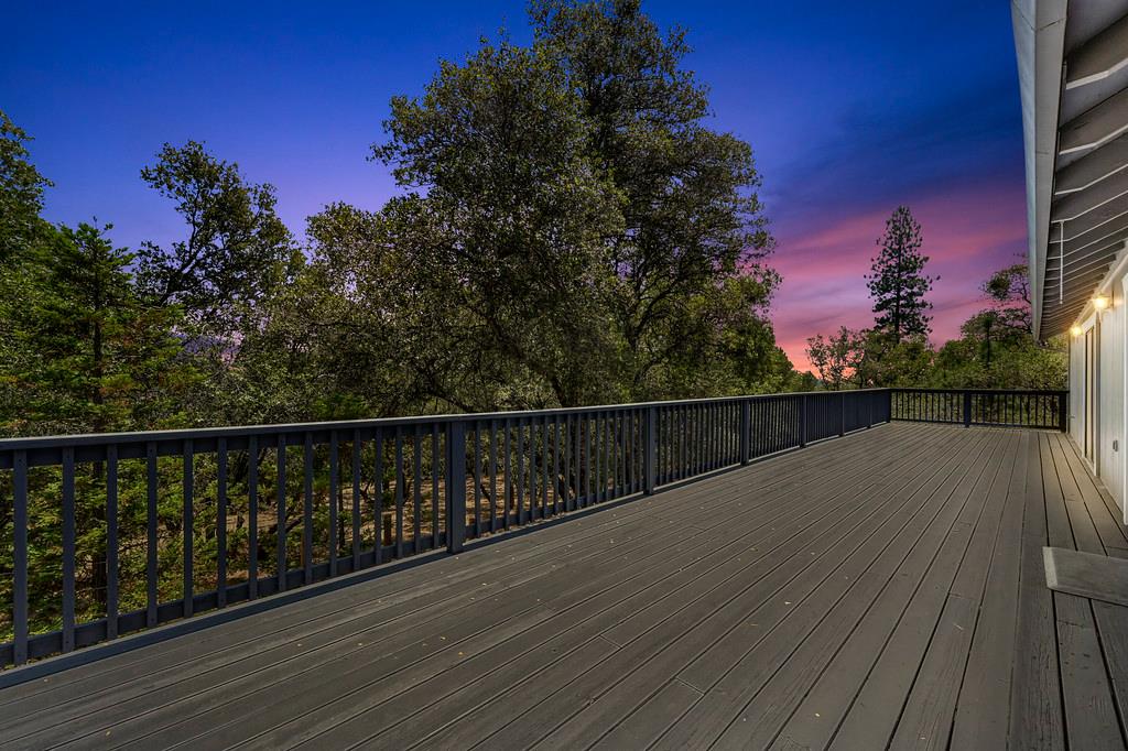 2071 Bogus Point Court Cool, CA 95614 - Photo 9 of 69 a view of balcony with wooden floor and trees in the background