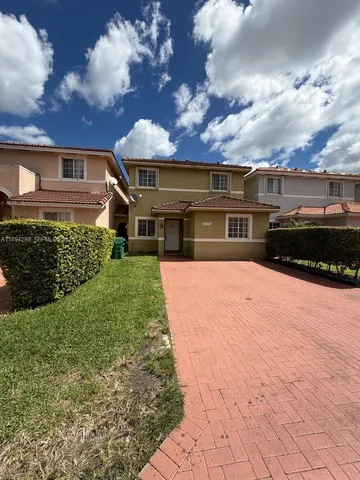 a view of houses with yard