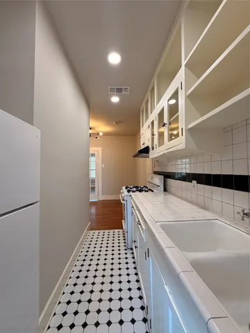 a kitchen with a sink and a refrigerator